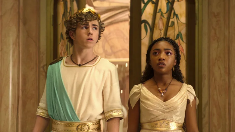 Percy Jackson and Annabeth wearing Greek robes and looking on